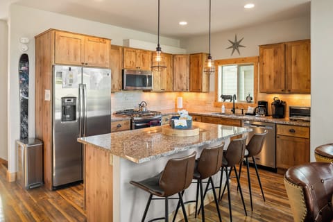 - Modern kitchen with stainless appliances and wood cabinetry   - Granite island and bar seating for group dining   - Fully equipped vacation rental for mountain getaways