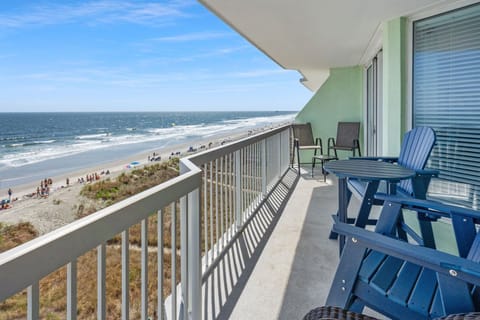 Oceanfront balcony with blue Adirondack chairs at Paradise Pointe 4B, a 3-bedroom rental from Thomas Beach Vacations
