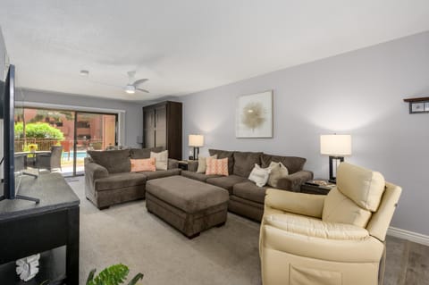 Spacious living room with cozy seating and garden views