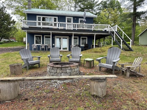 Lake side with fire pit and chair s