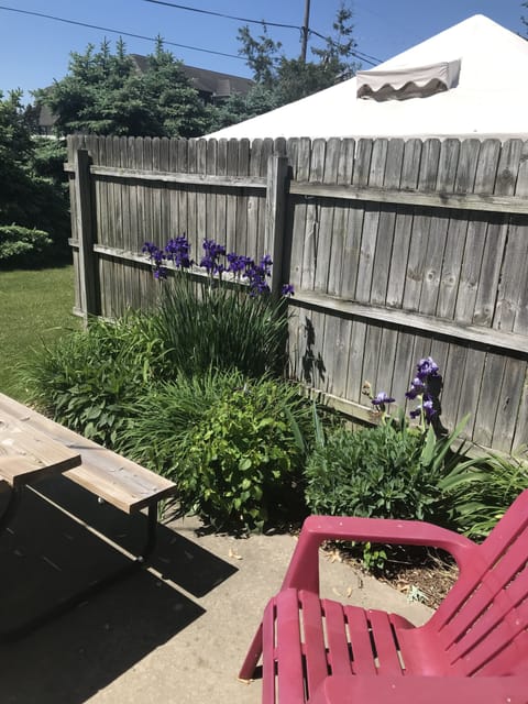 Sunny back porch includes and grill and fire table.