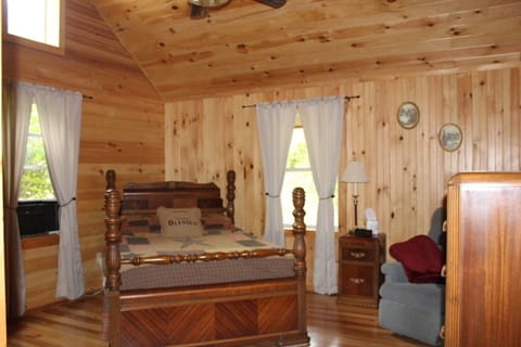 Master bedroom with a dresser and sitting chair. 