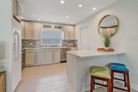 The kitchen is fully stocked with flatware, dishes, cups, pots, pans, and more.