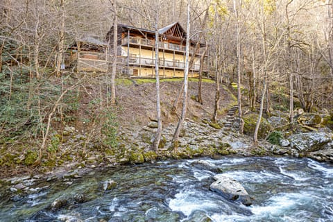 Secluded river view of the lodge. The decks run the width of the house.Check out the backyard! Fishing. Explore the river bank. Sit & watch the water.