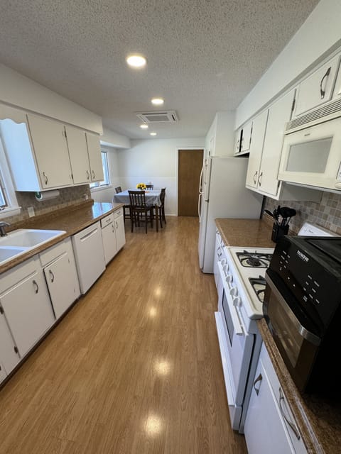 Fully equipped kitchen with high top table with 4 chairs. Door to laundry room 