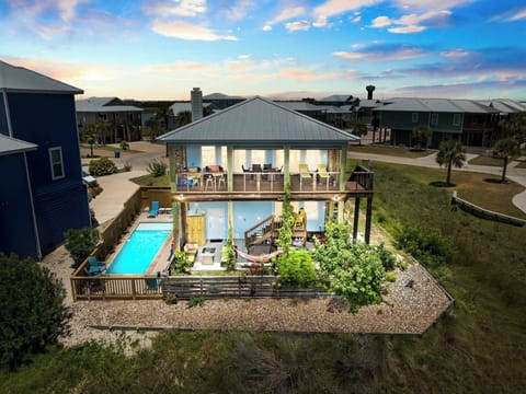 See the home and neighborhood bathed in the soft glow of twilight — where peaceful evenings and stunning views come together. Your Port Aransas escape awaits!