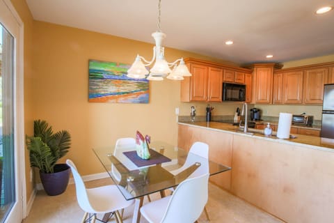 This dining table in the kitchen also seats 4 and has sliding door access to the open patio.