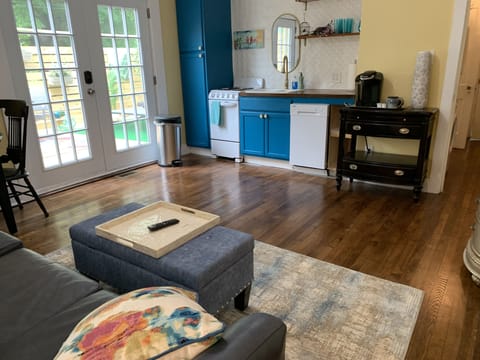 Leather couch and comfy ottoman with view to outdoors and deck