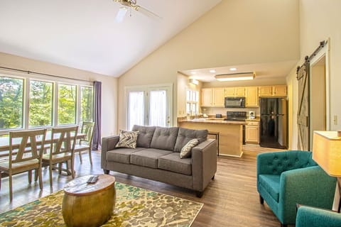 Upper level open floor plan includes living area, full kitchen, and dining area