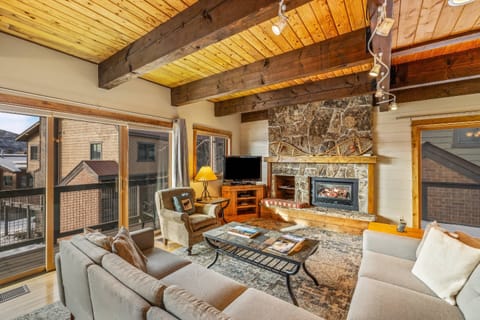 Catch your favorite shows on the large flat-screen TV mounted above the rustic wood mantle.