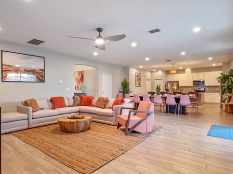 - Spacious living area with sectional seating and TV  
- Open concept design flows into modern kitchen space  
- Family friendly Orlando rental for large gatherings