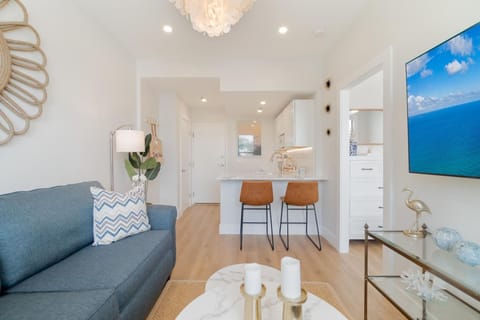 Living Area. Smart flat screen Tv and AC. Fully stocked kitchenette with 2 seater bar counter.