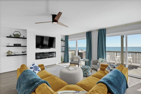 Spacious living room with large TV, modern fireplace and unbeatable ocean views!