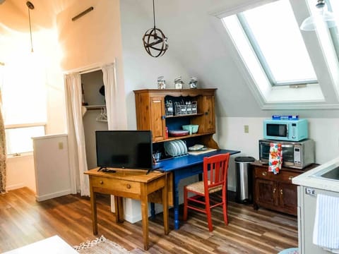 Kitchen hutch stores dining/server/drink ware. 