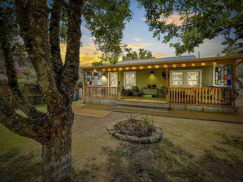 Your cozy getaway awaits! Relax and unwind on the porch of this charming vacation rental, surrounded by nature and illuminated by a beautiful sunset