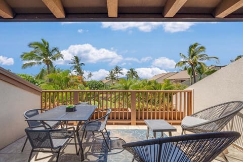 Enjoy relaxed outdoor dining on this beautiful lanai with palm‑framed views and a comfortable table for four