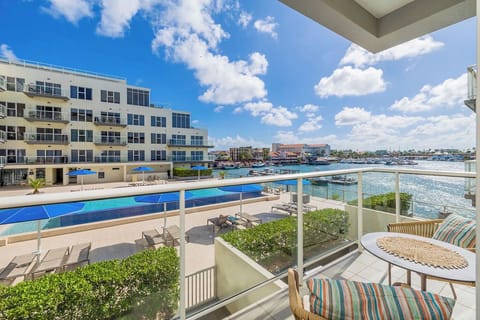 A waterfront property featuring pools and marina views, positioned along a calm harbor with easy access to nearby attractions and recreational facilities.