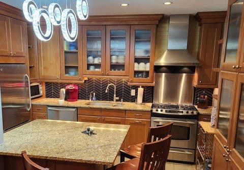 Full Chef's Kitchen with Stainless Steel Oven, Dishwasher, Microwave/Bake Oven, Exhaust Hood, Garbage Disposal, Silverware and Pots and Pans.