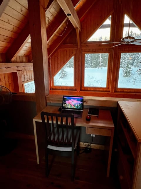 Desk and chair set up on upper landing to work remotely