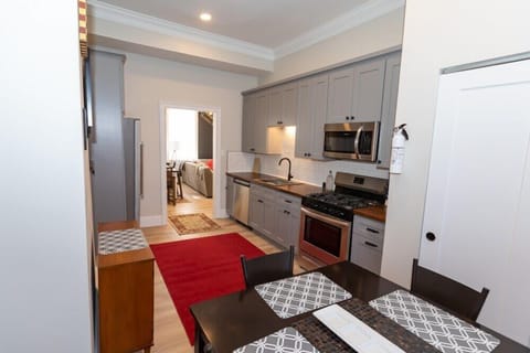 A luxuary kitchen, with plenty of cabinets and cooking prep space.  Large 6 burner stove, coffee station, and smaller table. 