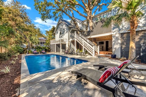 Private backyard retreat featuring a sparkling pool and relaxing lounge chairs.