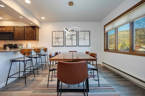 Gather around your stylish dining table for meals with stunning mountain views streaming through expansive windows.