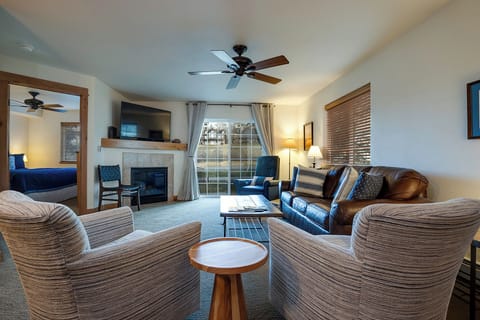 Sink into comfortable seating around the cozy fireplace, where warm wood tones and soft lighting create your perfect retreat.