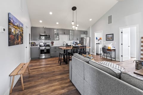 View of kitchen, dedicated workspace, and dining area from the entry to the home