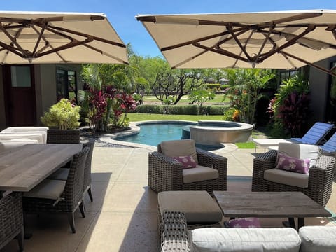 Relax and enjoy the beautiful tropical garden with views of the golf course