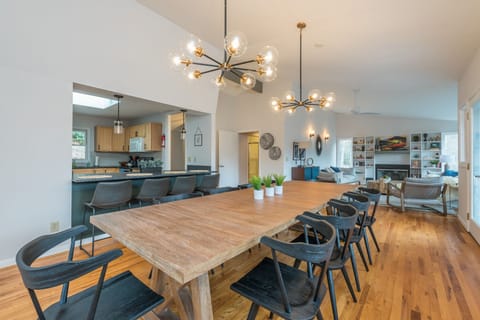 Share meals at the dining table situated conveniently next to the kitchen, fostering easy conversation and connection.