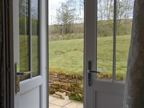 Doorway from bedroom to garden | No 2 Railway Cuttings - Railway Cuttings, Falstone, near Kielder