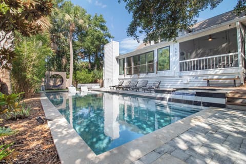 Your private pool awaits beneath swaying palms, surrounded by lush tropical landscaping and a spacious sun deck perfect for lazy afternoons.