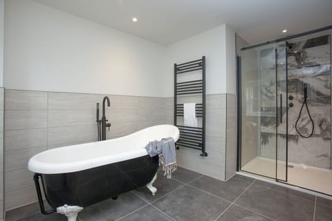 Modern bathroom with freestanding bath, heated towel rail and walk in shower - Golden Vanity Suite