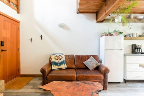 The leather couch is perfect for watching Netflix and can be pulled out to act as an extra bed.