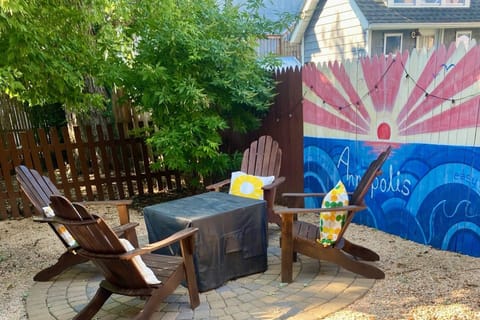 Enjoy Eastport Easy's private backyard retreat's fire pit and fenced-in yard.