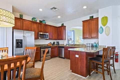 Spacious kitchen with modern appliances, granite countertops, and a cozy dining area.