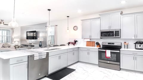 Bright, modern kitchen with sleek appliances, ample counter space, and style.