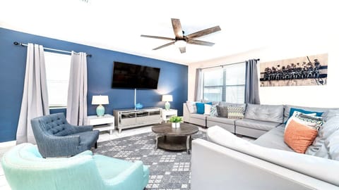 Bright and modern living room with cozy seating, smart TV, and stylish décor