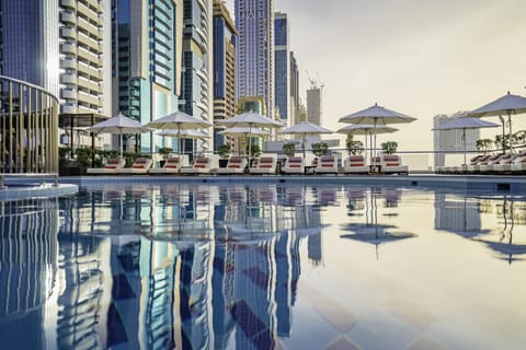 Outdoor pool, open 7:00 AM to 11:00 PM, pool umbrellas, sun loungers