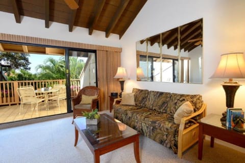 Step into your bright tropical living space where vaulted wood-beam ceilings and island-inspired décor create a relaxing vibe. Your private terrace overlooks lush palms, perfect for morning coffee or evening sunsets.