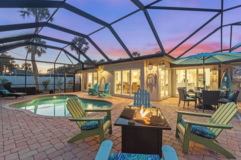 Pool and patio area with screened patio, fire pit and outdoor dining.