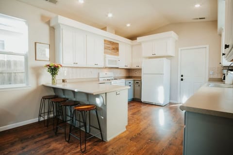 Enjoy morning coffee or late-night snacks at the kitchen island, perfect for casual conversations and connecting.