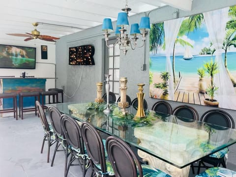 Our lanai is completely covered equipped with a large dinning table, bar, &TV