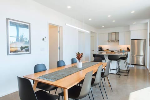 The dining room table has seating for 8, and is situated next to floor-to-ceiling sliding glass doors that open on to your private patio.