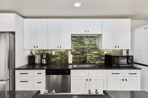 Kitchen with new appliances, well stocked supplies, and open feel (main level)