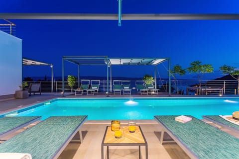 pool area with sun deck in front of the living room