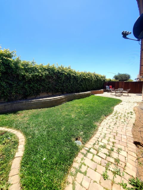 Backyard with two patios sets.