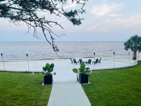 Professionally landscaped lawn leading onto your private 144 ft. beach. 