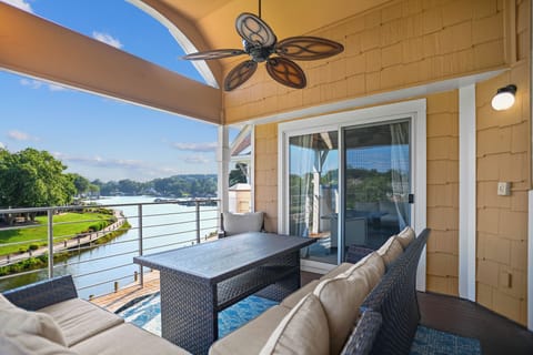 Welcome to Lavish Lake Lounge. Deck with sectional seating, lake views and ceiling fan.