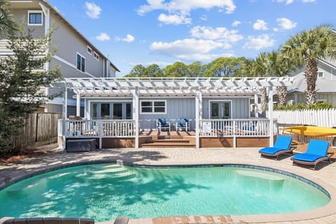 Dive into your private oasis with a sparkling pool and spacious deck perfect for lounging under the pergola.